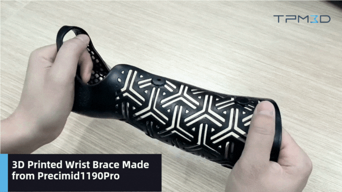 Black Precimid1190Pro perforated wrist brace flexed by hand