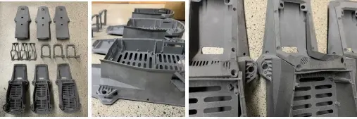 Batch-produced SLS nylon drone airframe components with integrated ribs, vents, and mounting features